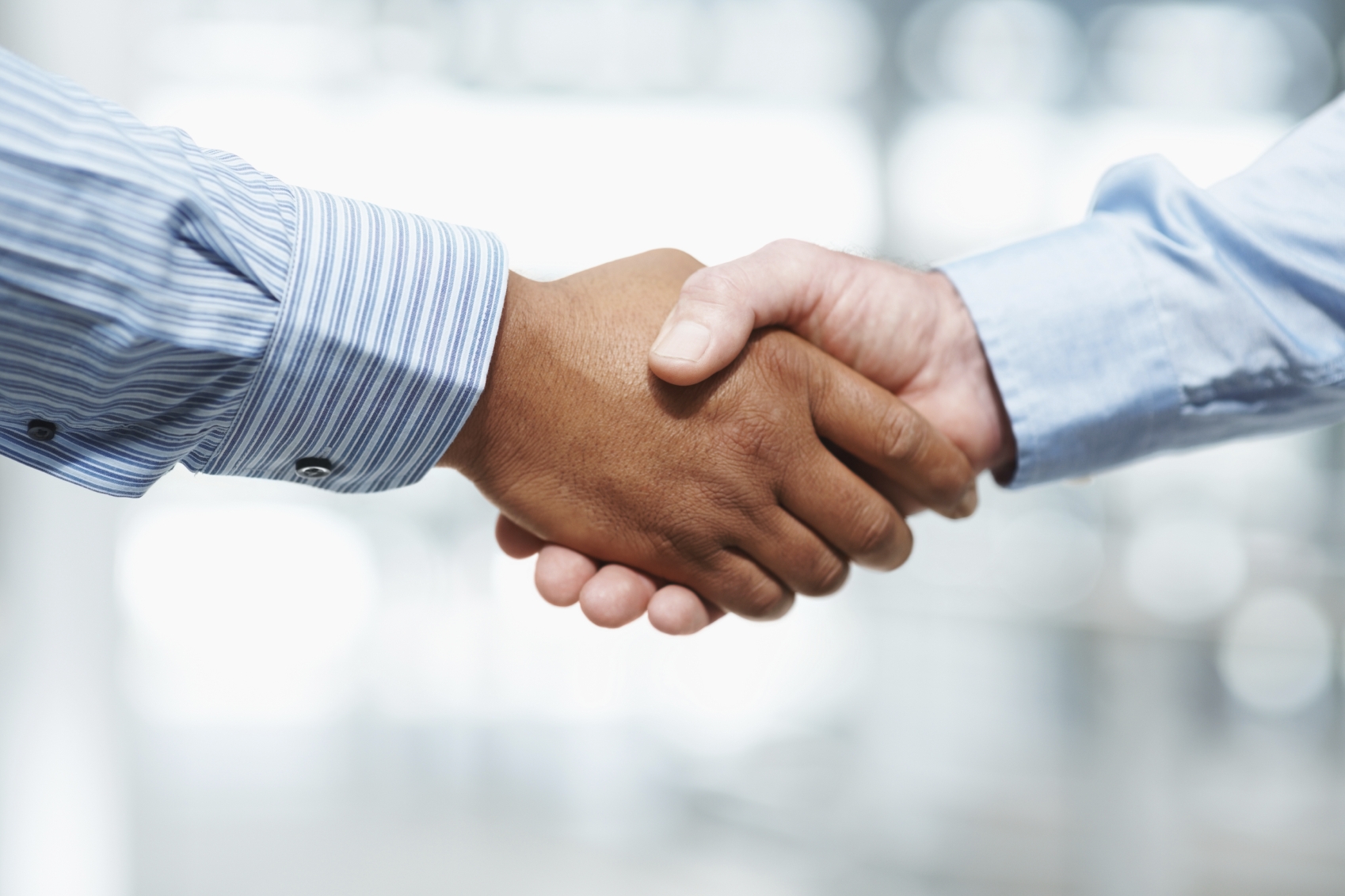 Business deal – Closeup of a handshake against blur background